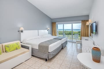 a room with a bed and a chair and a table