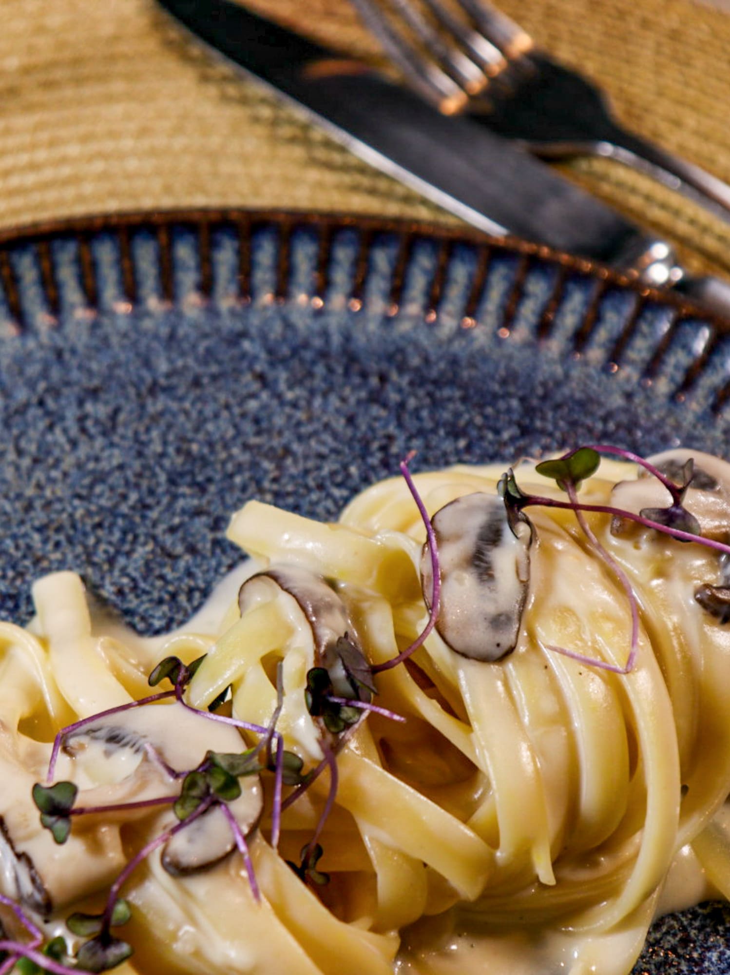 a plate of pasta with mushrooms on it