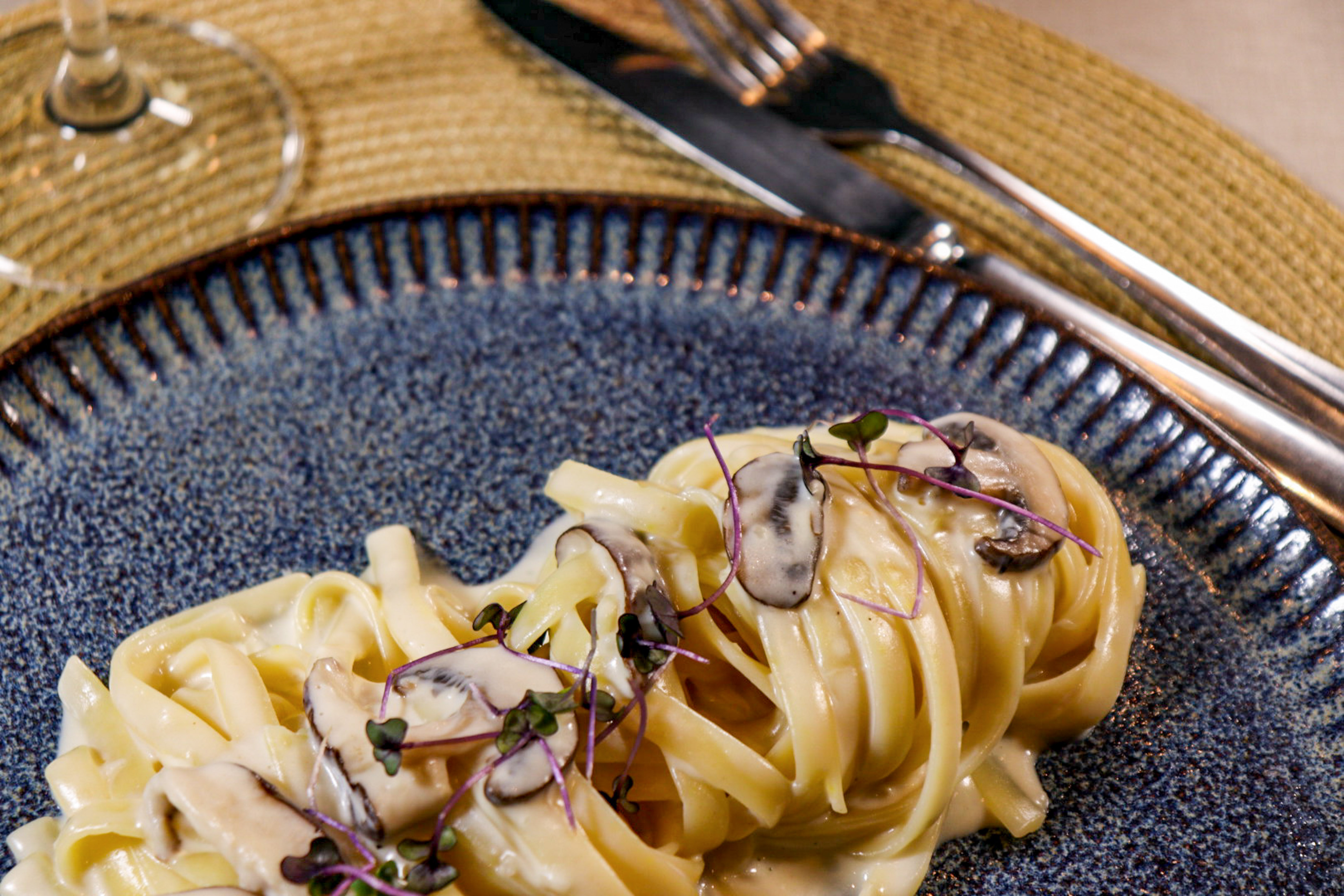 a plate of pasta with mushrooms on it