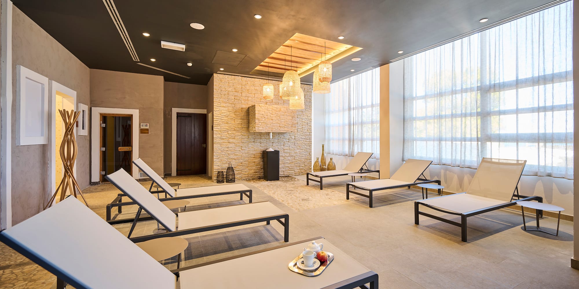 a room with lounge chairs and a fireplace