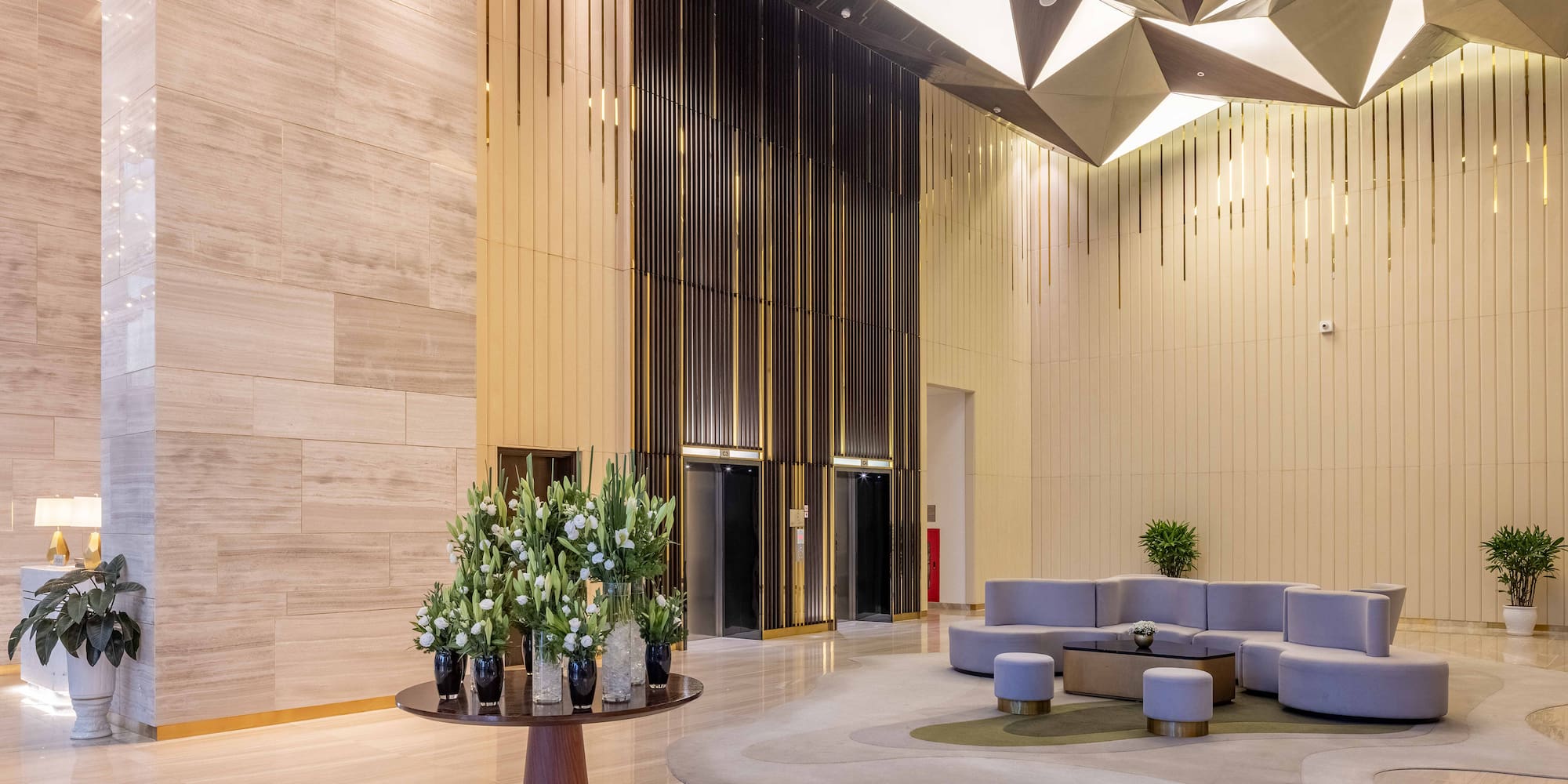 a lobby with a round table and chairs