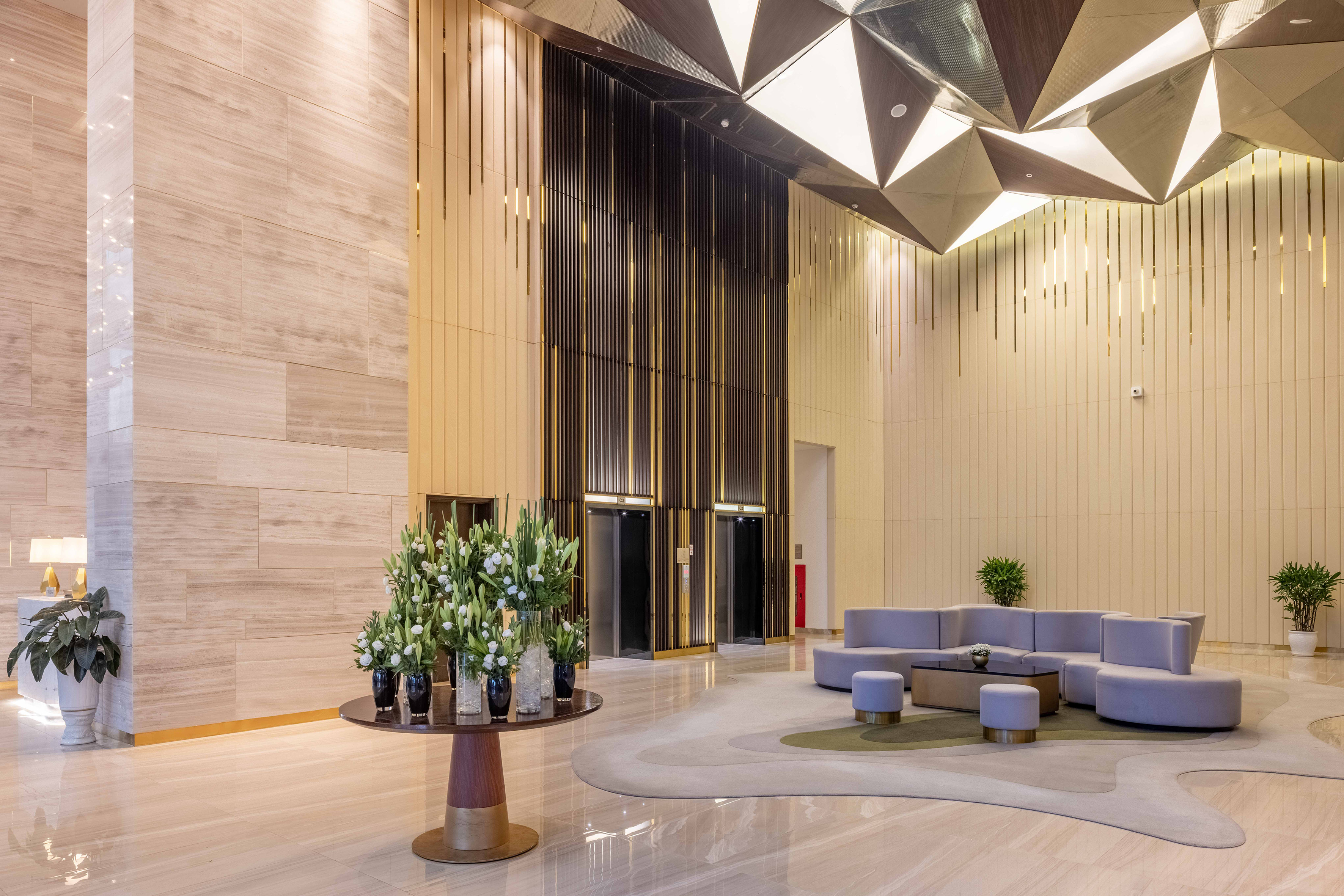 a lobby with a round table and chairs