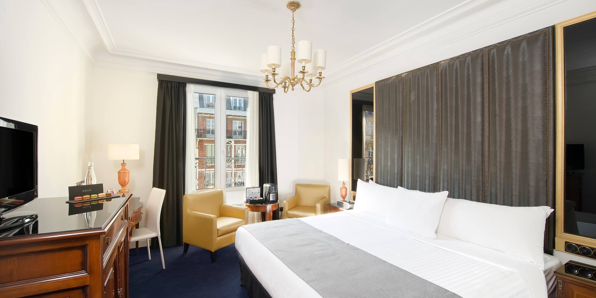 a room with a bed and a desk