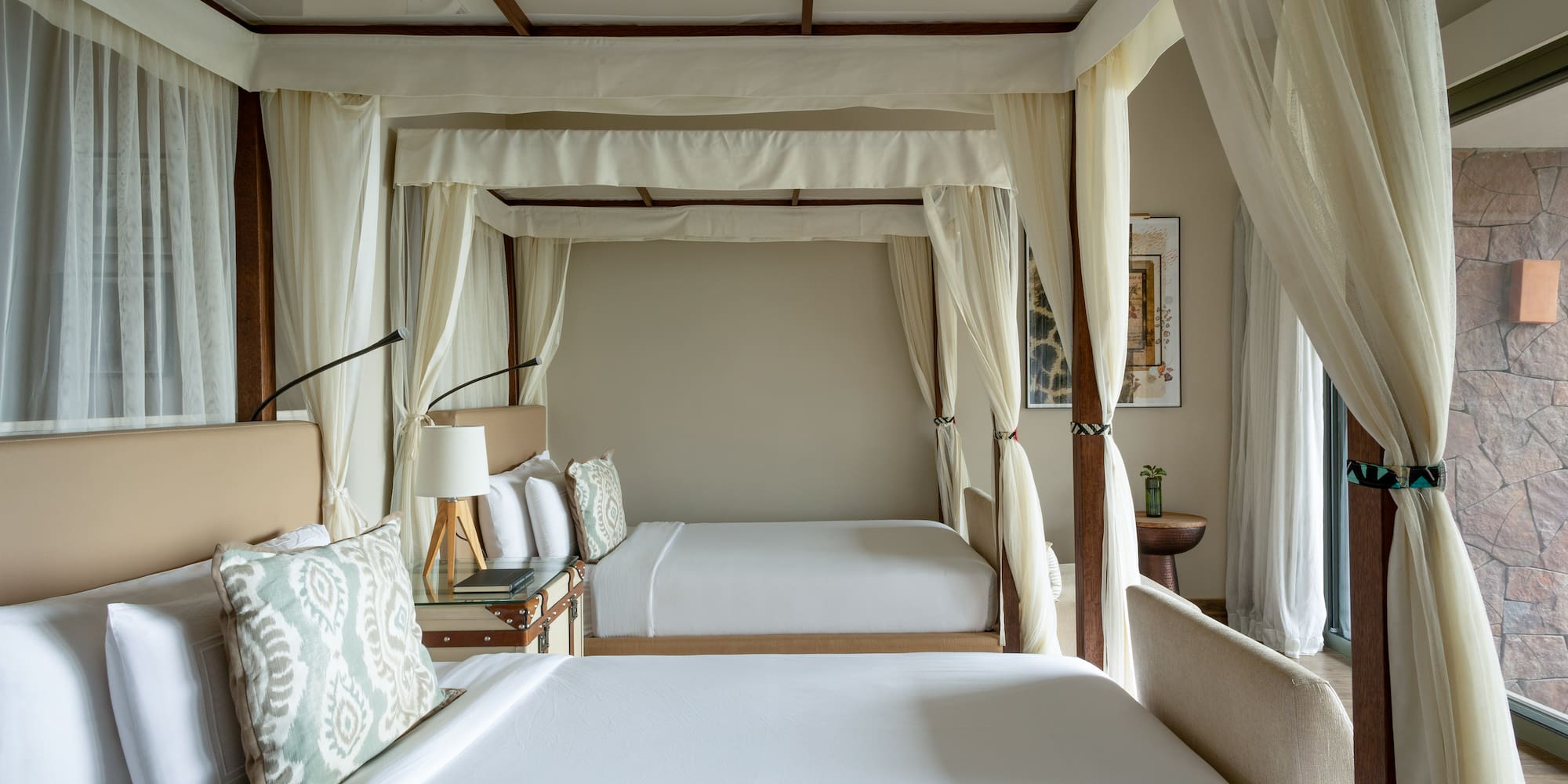 a room with two beds and a canopy bed