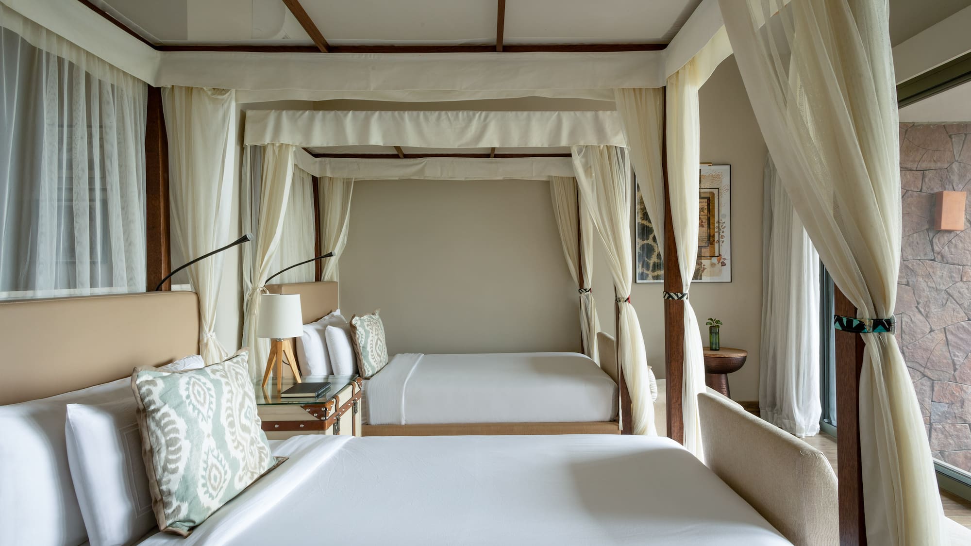 a room with two beds and a canopy bed