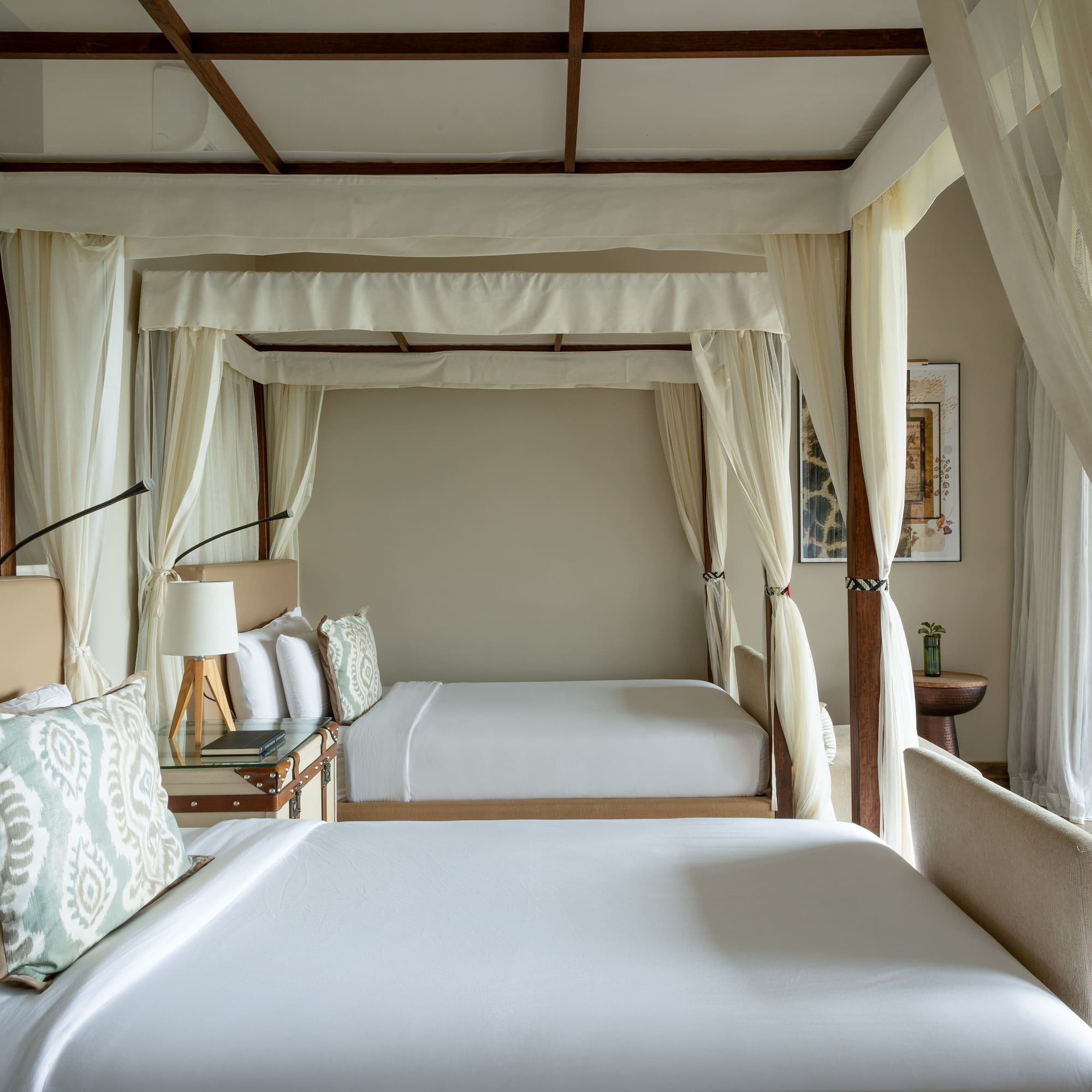 a room with two beds and a canopy bed