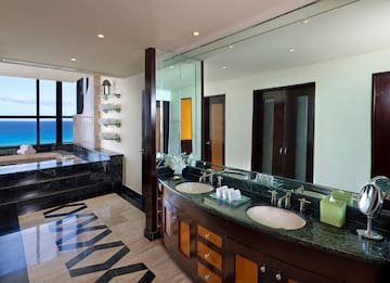 a bathroom with a large mirror and a large tub