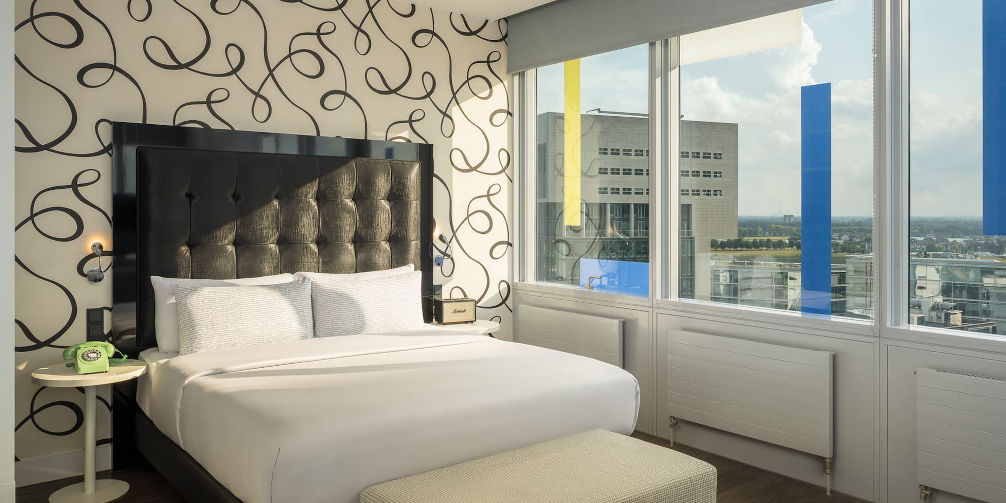 a bed in a room with a large window