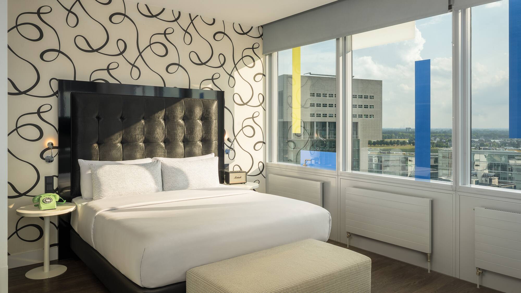 a bed in a room with a large window