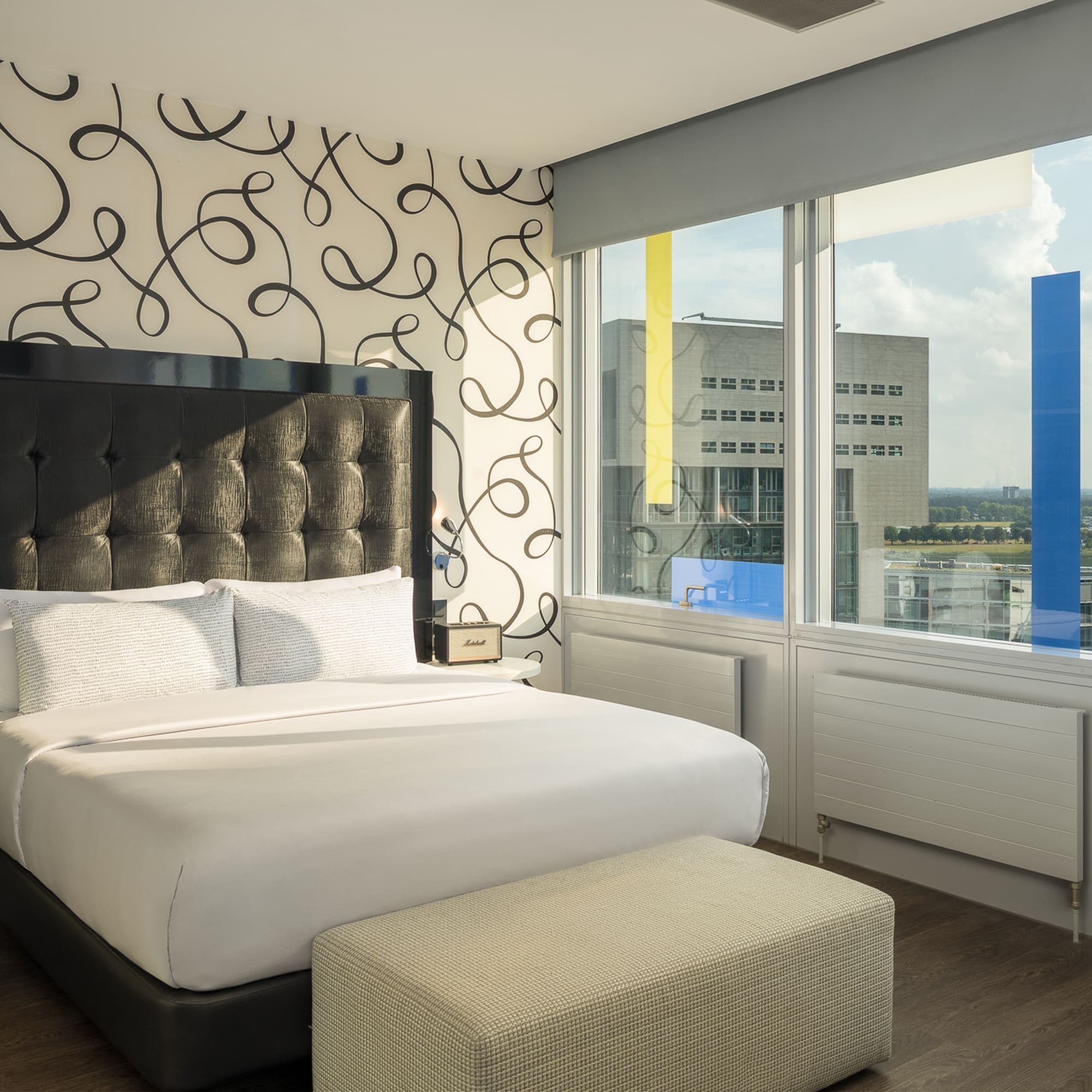 a bed in a room with a large window