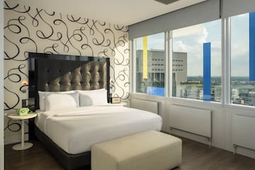 a bed in a room with a large window