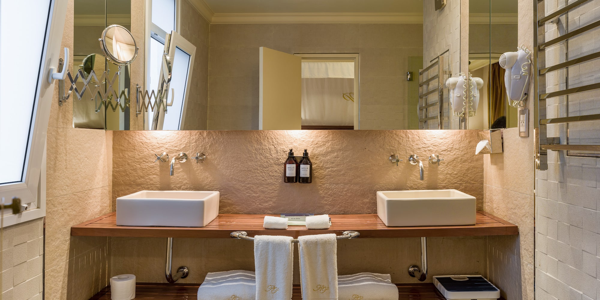 a bathroom with two sinks and a large mirror