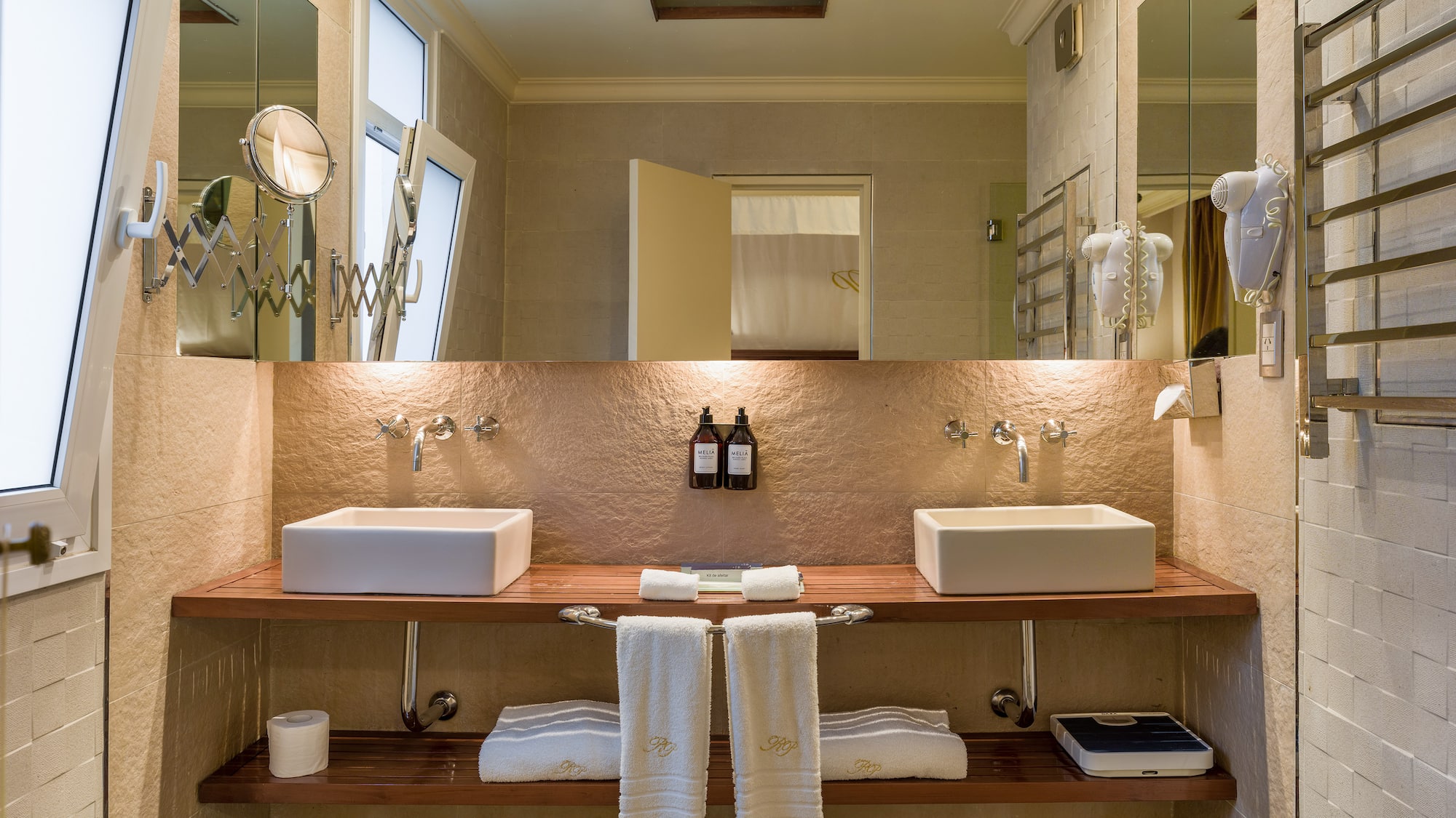 a bathroom with two sinks and a large mirror