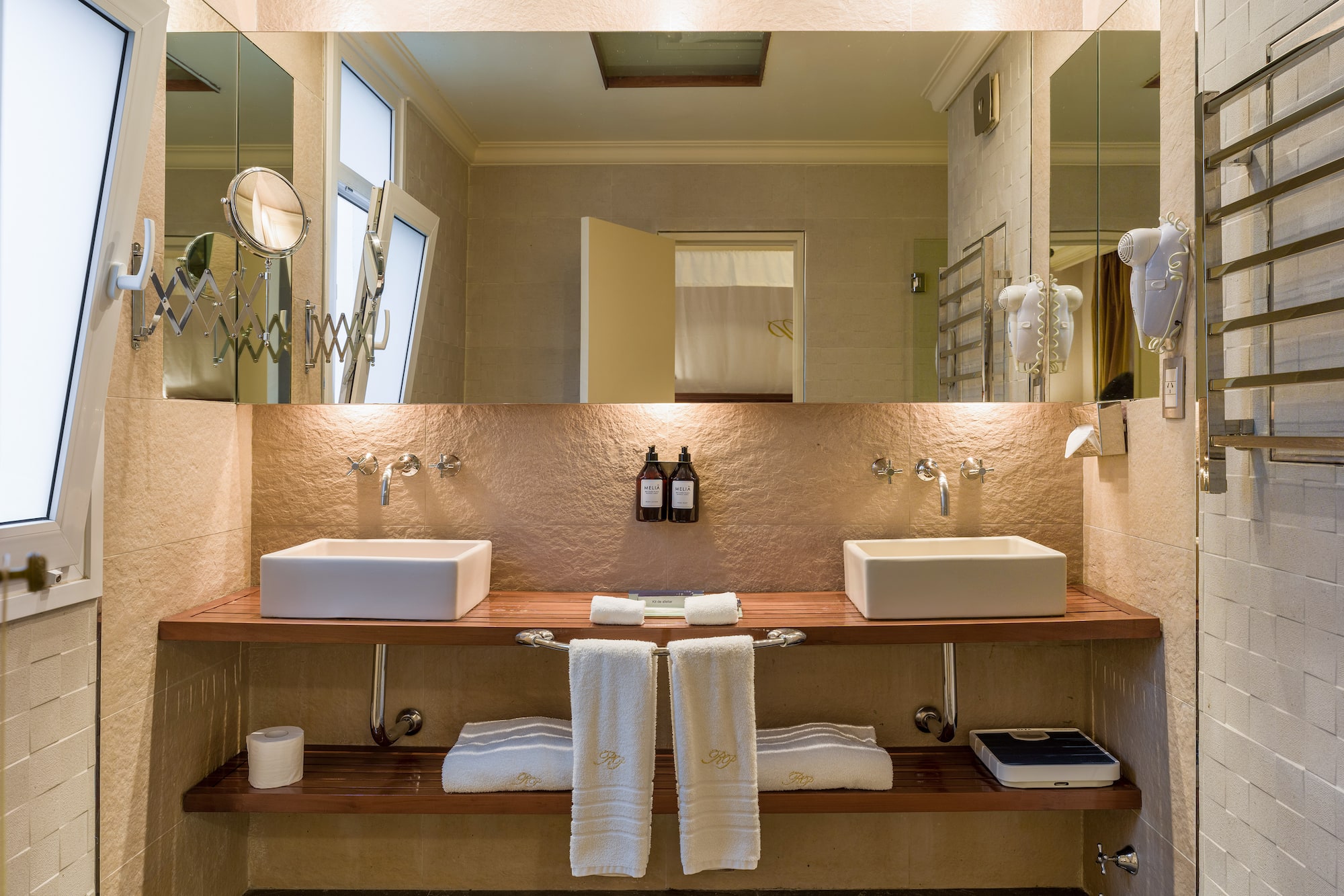 a bathroom with two sinks and a large mirror