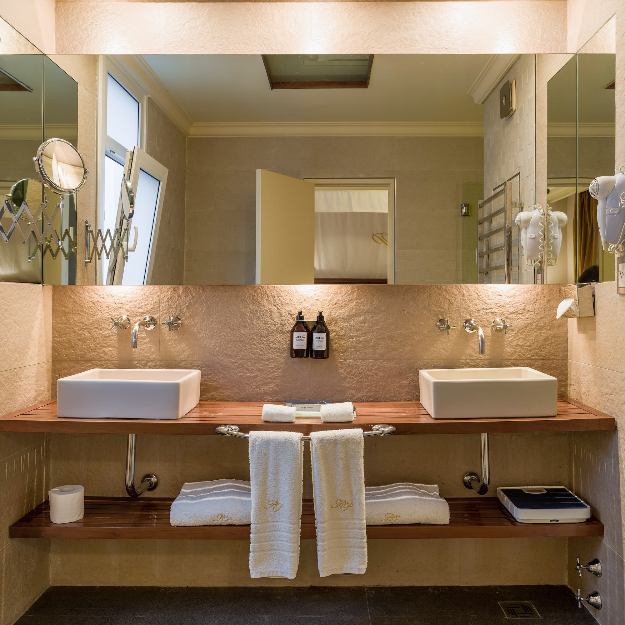 a bathroom with two sinks and a large mirror
