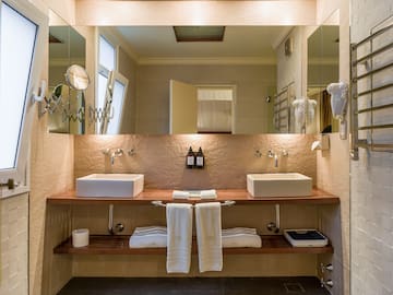 a bathroom with two sinks and a large mirror