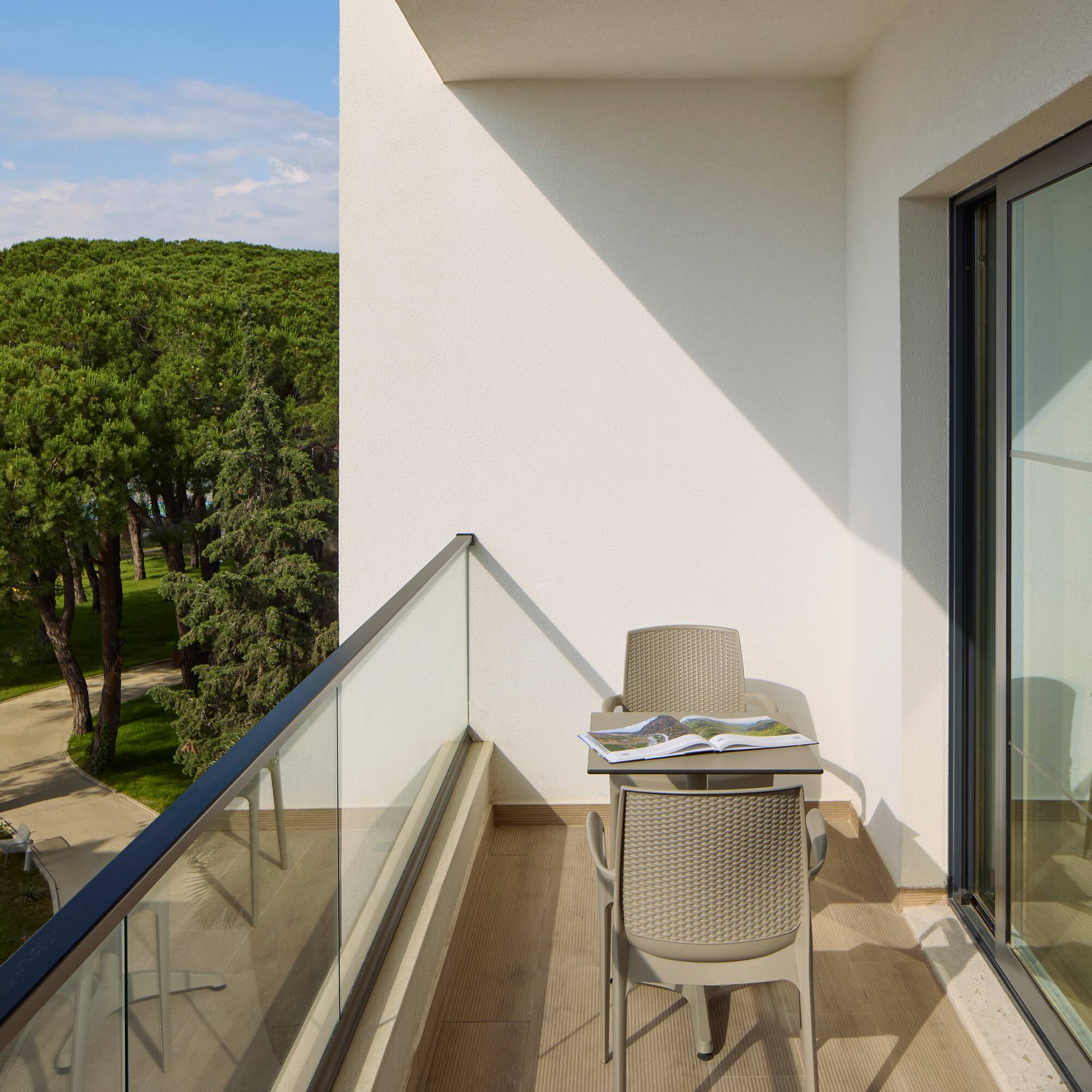 a chair and table on a balcony