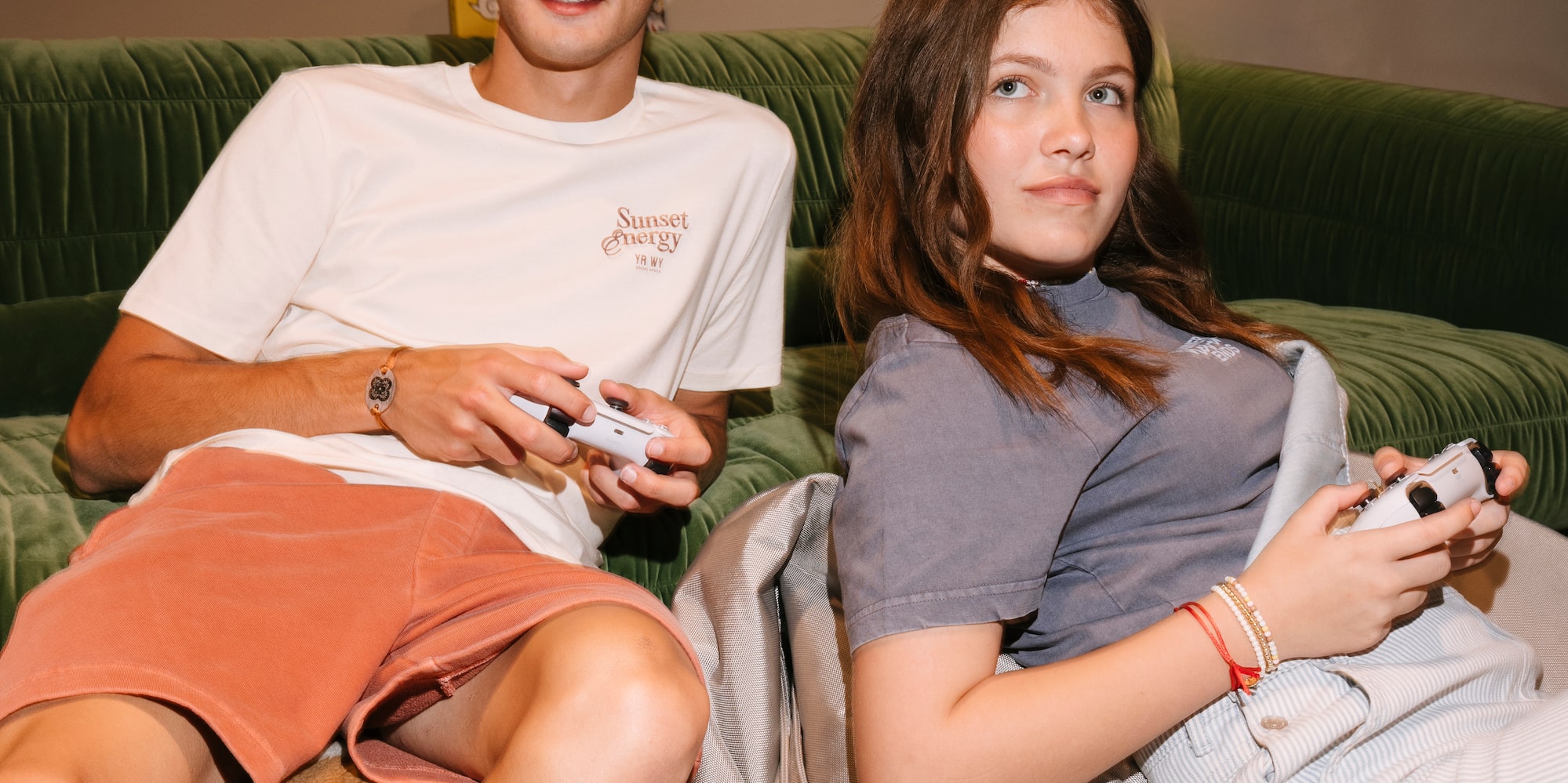 a man and woman sitting on bean bags playing video games