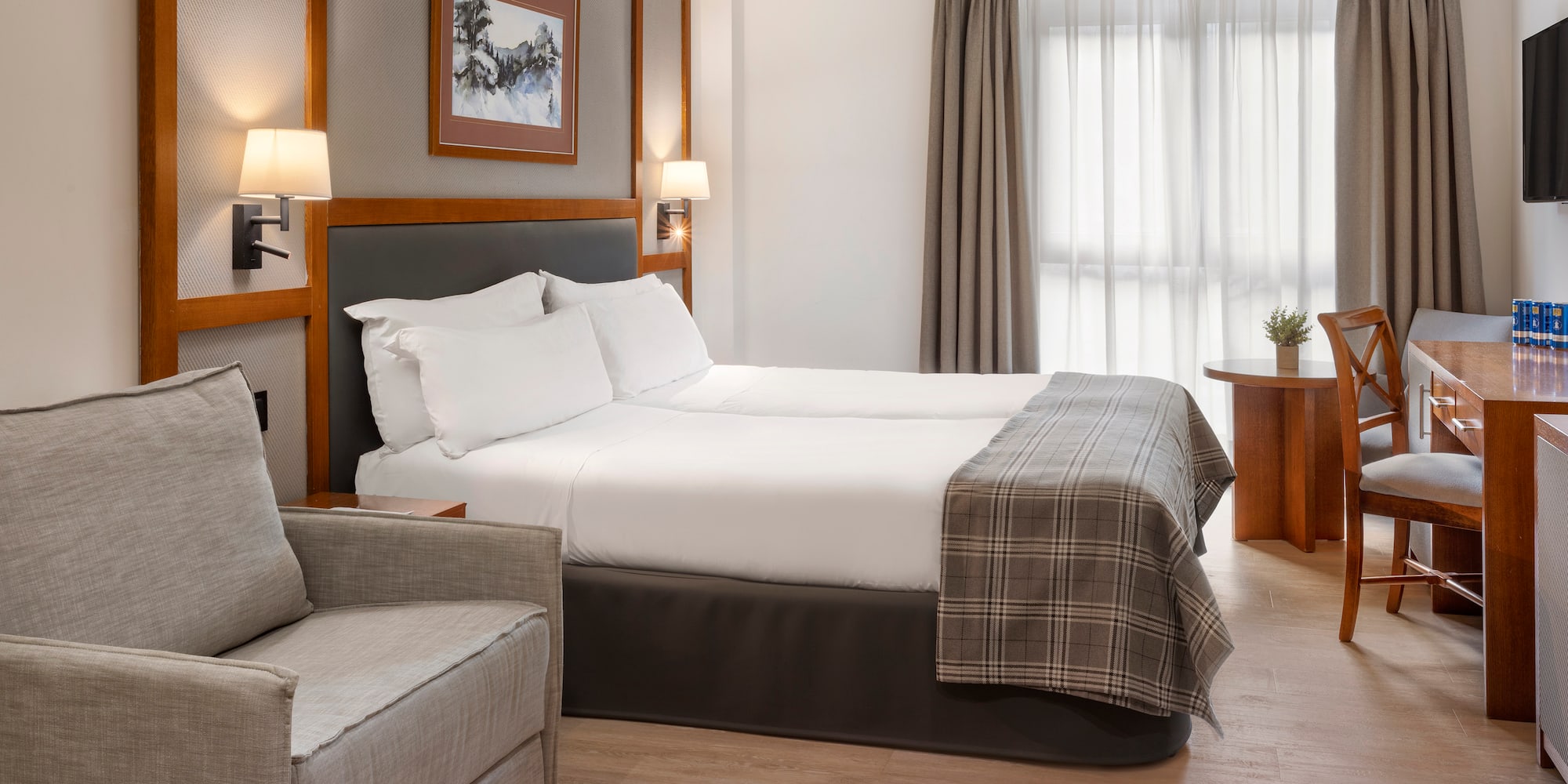 a room with two beds and a chair