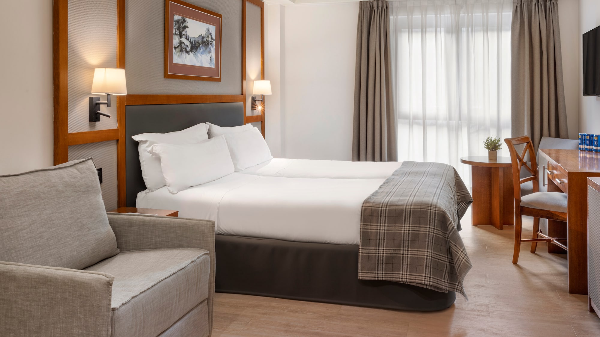 a room with two beds and a chair