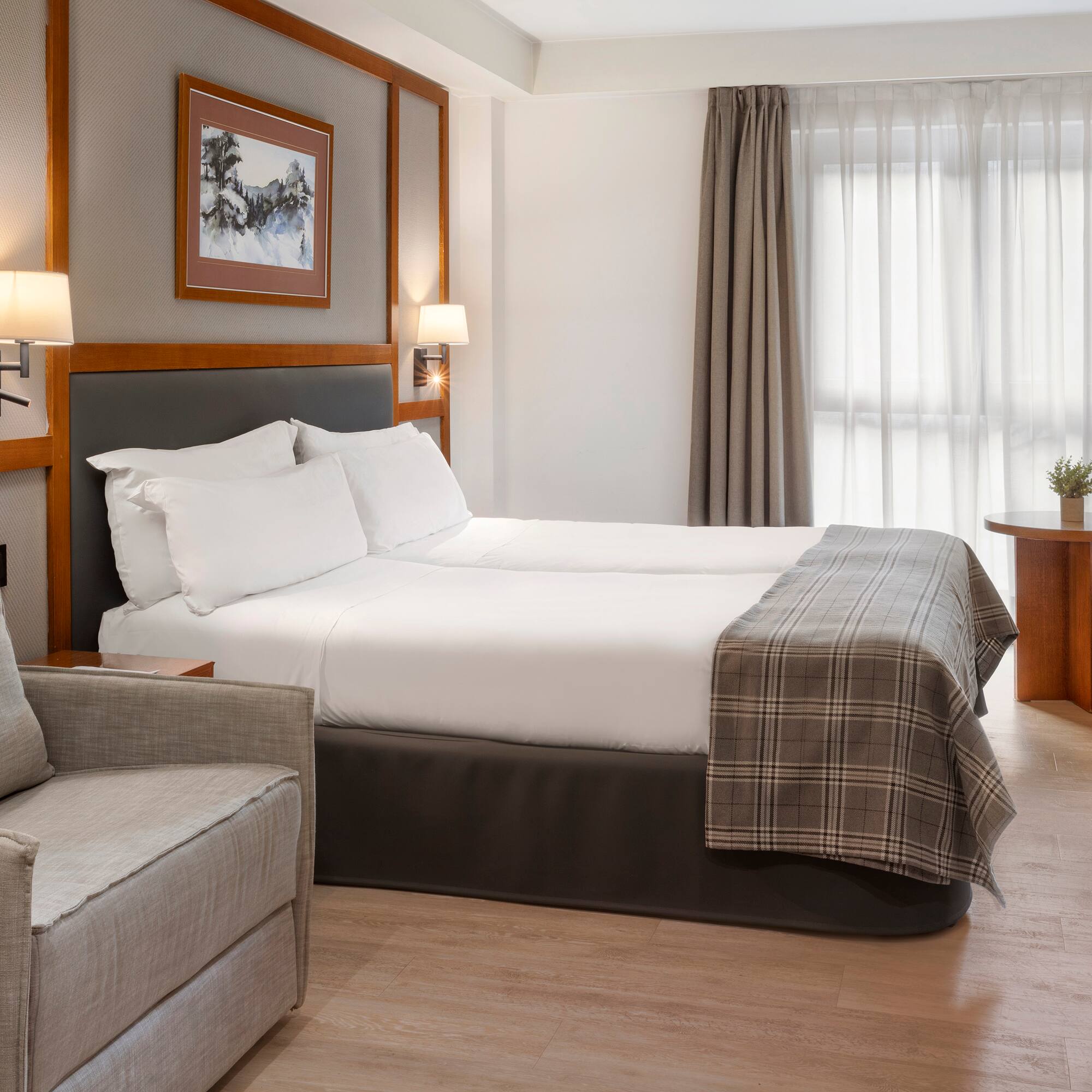 a room with two beds and a chair