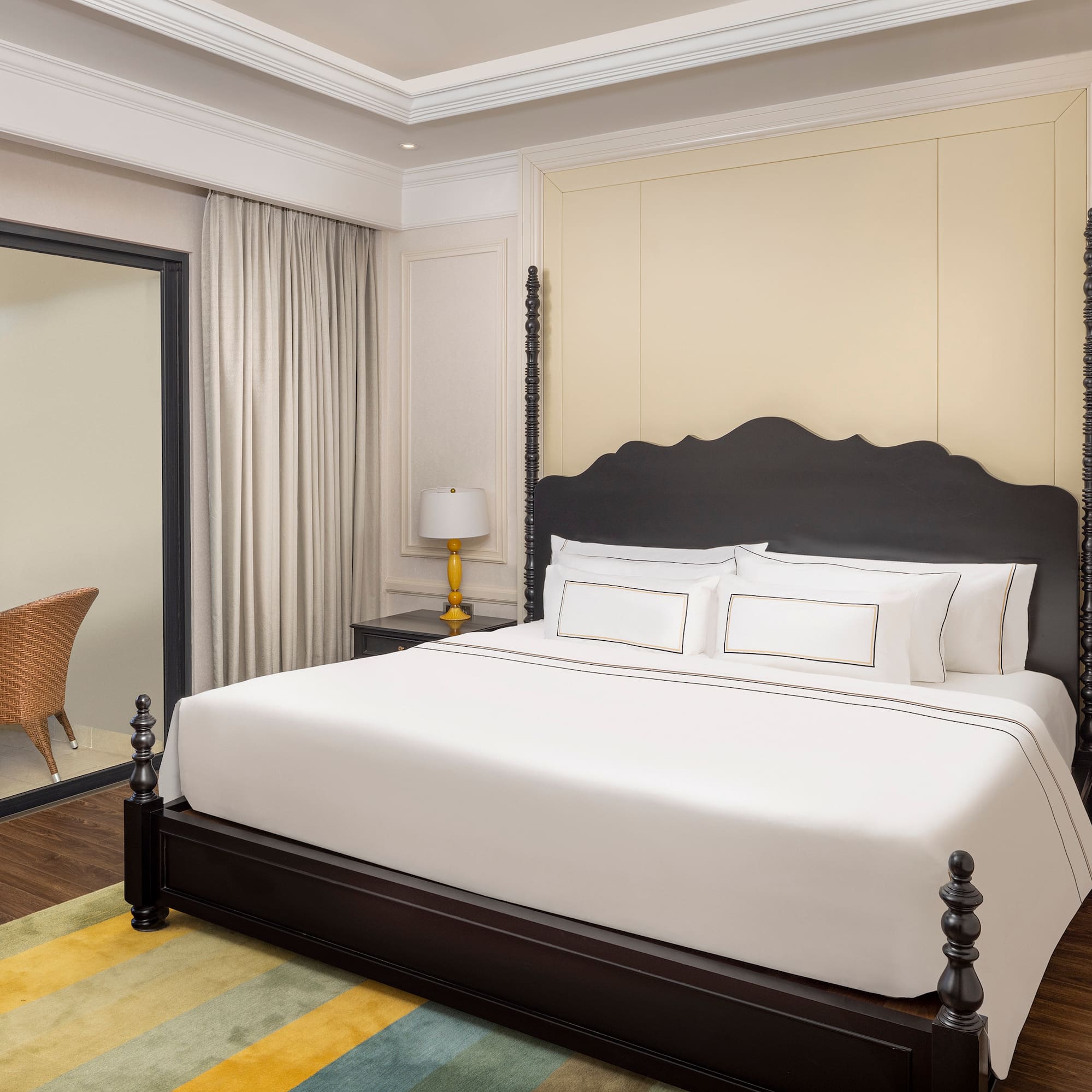 a bed with white sheets and a black headboard