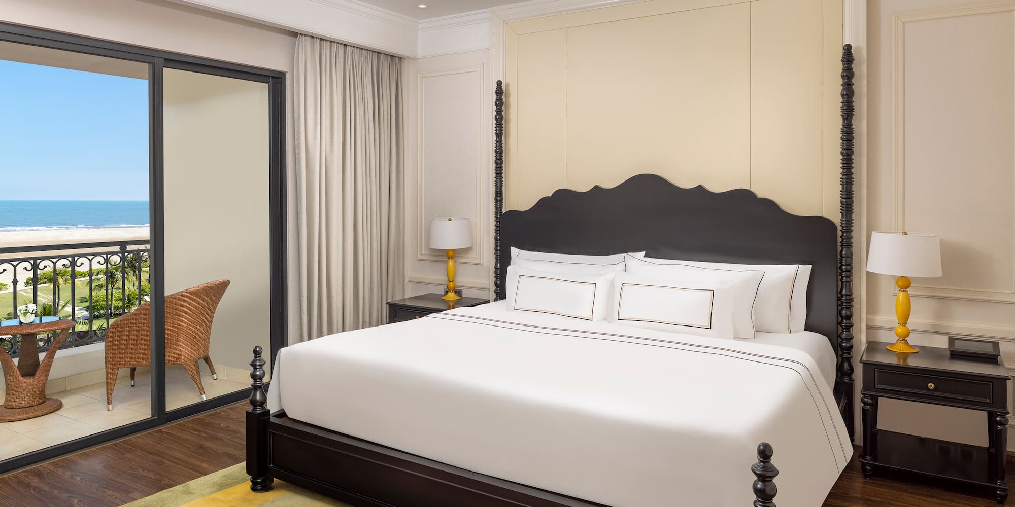 a bed with white sheets and a black headboard