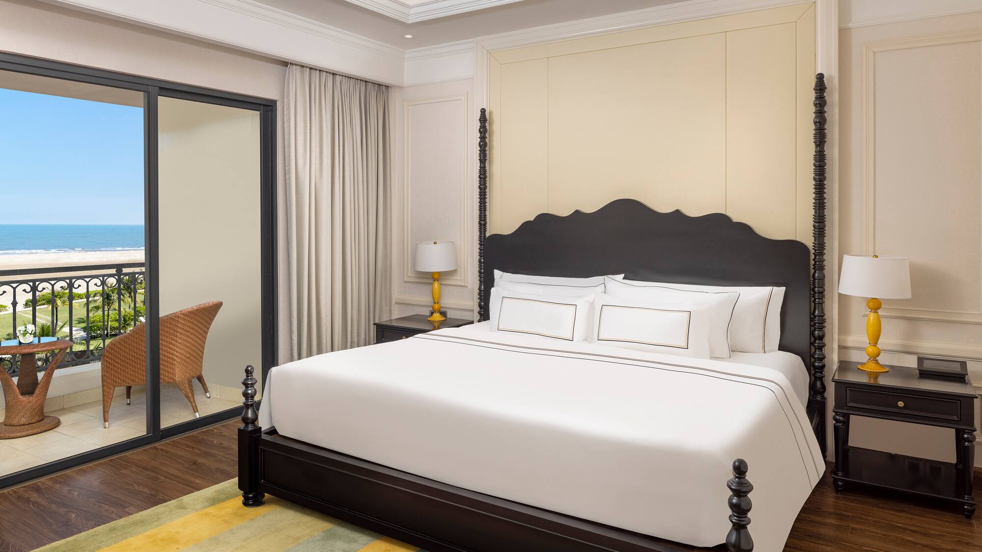 a bed with white sheets and a black headboard