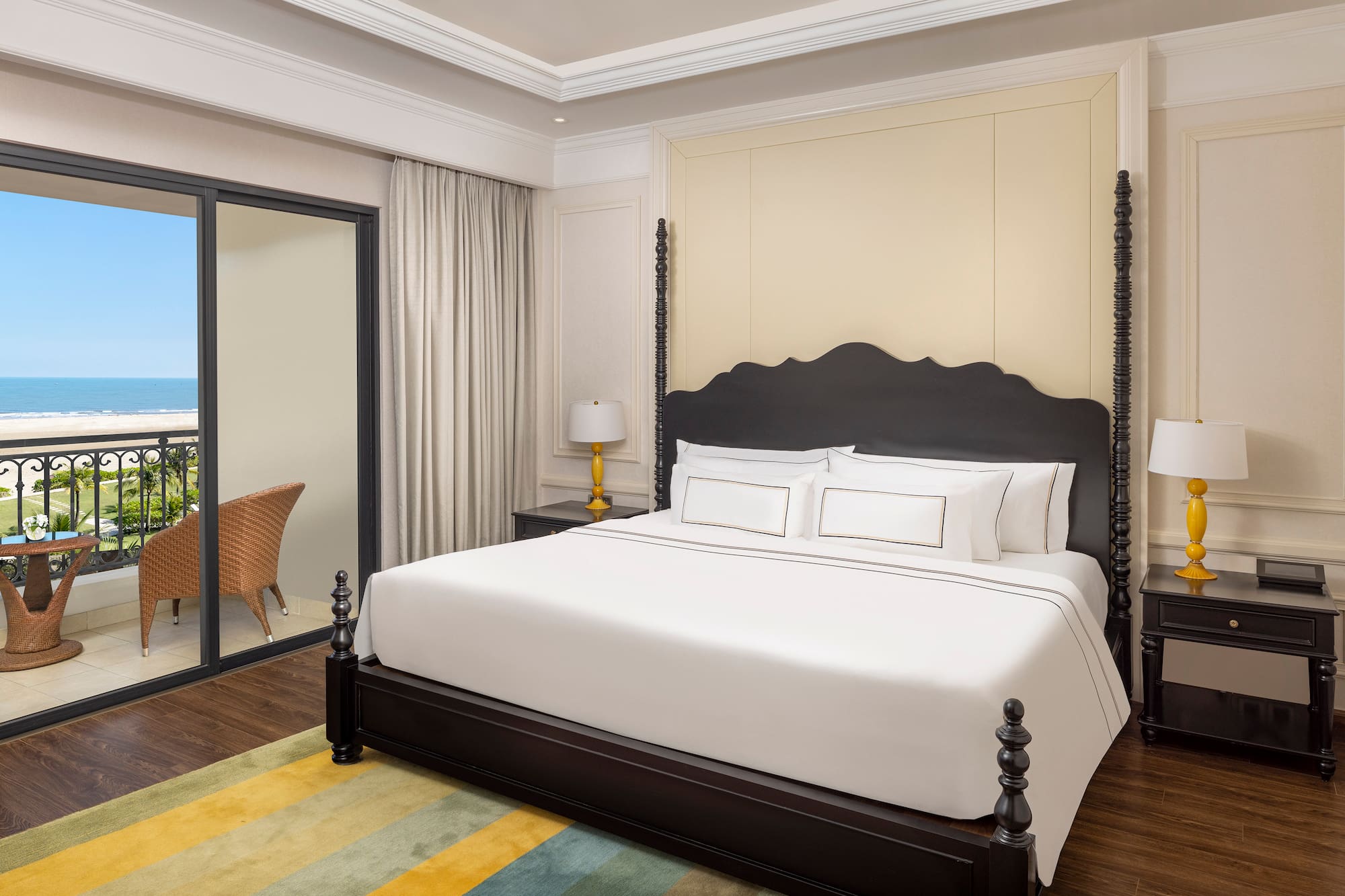 a bed with white sheets and a black headboard