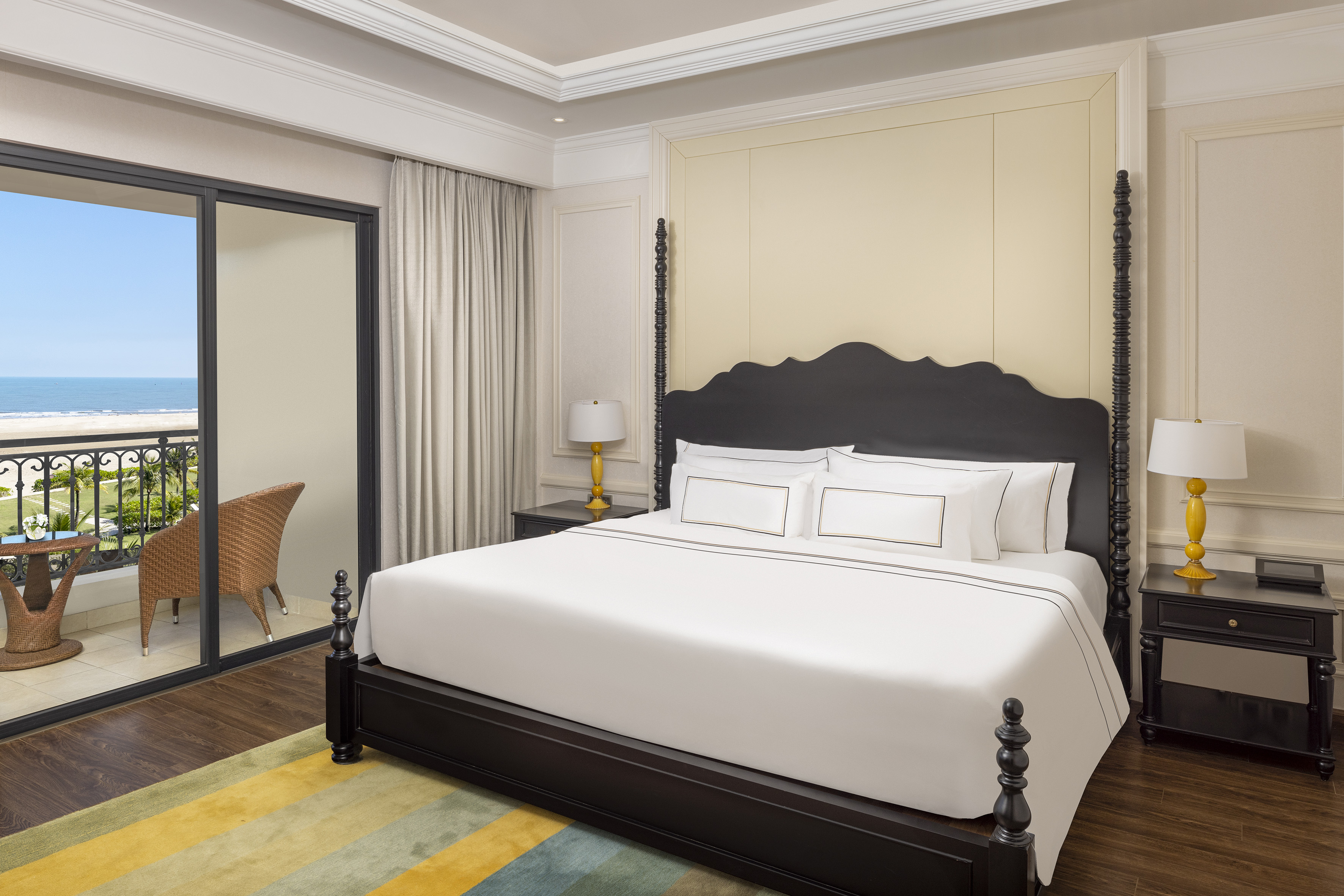 a bed with white sheets and a black headboard