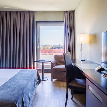 a room with a bed and a desk and chair
