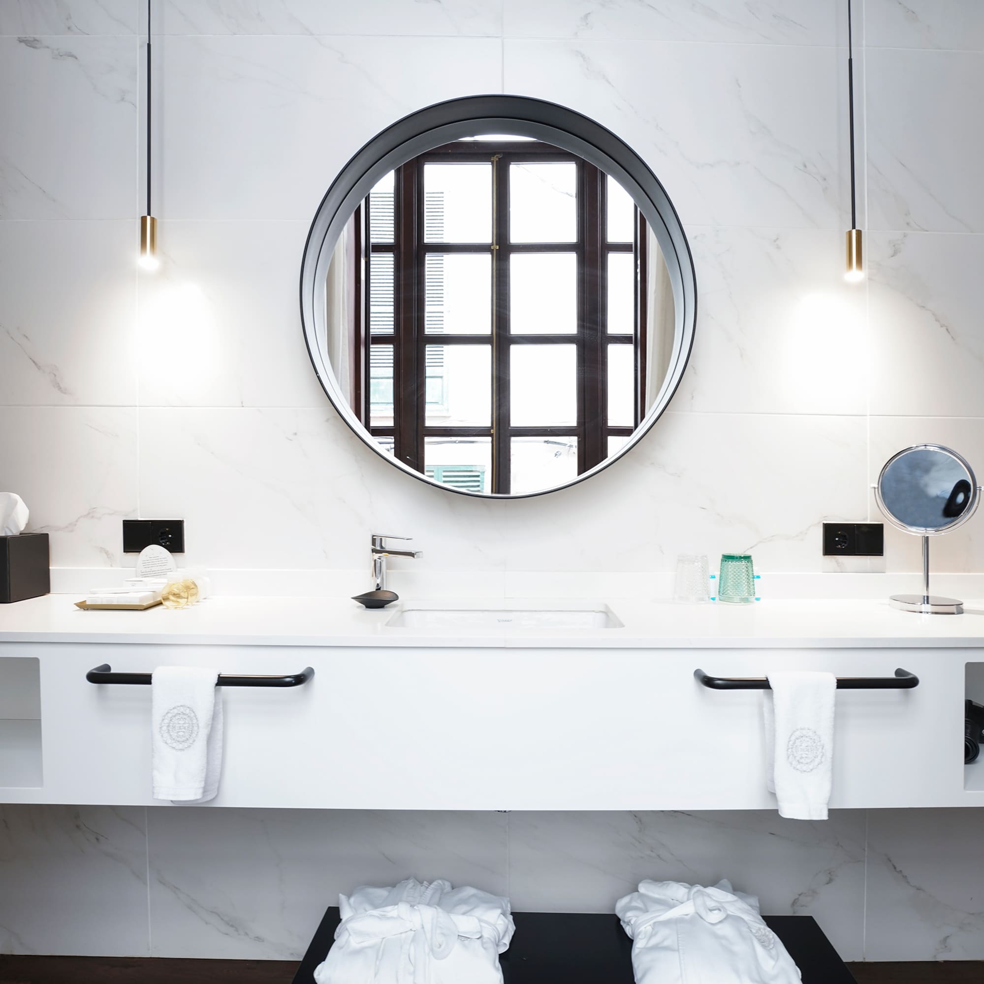 a bathroom with a round mirror