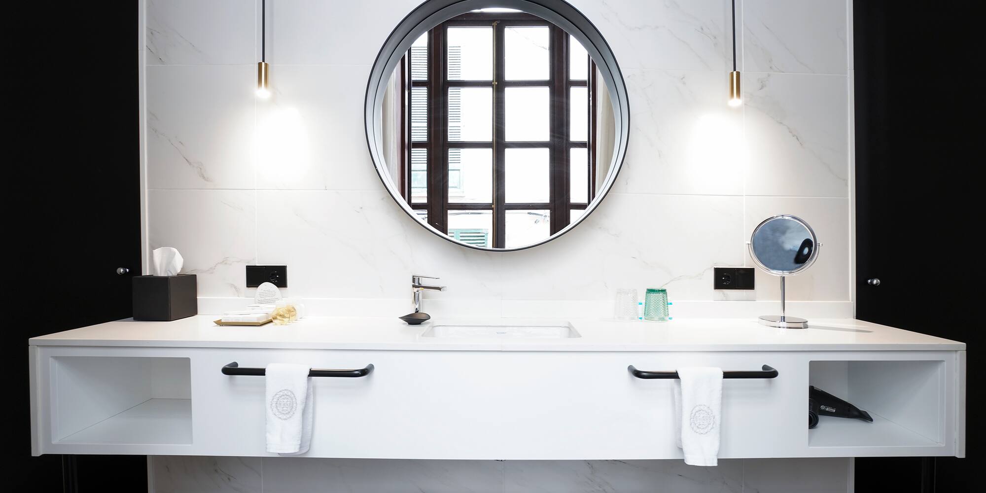 a bathroom with a round mirror