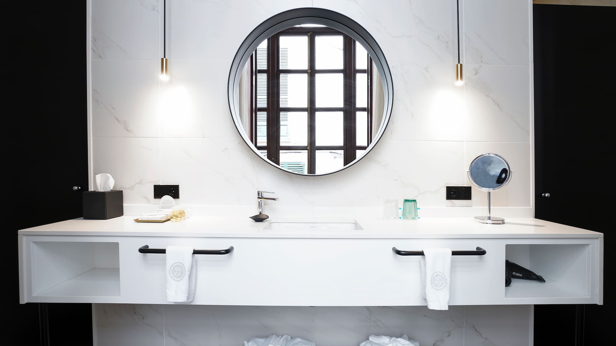 a bathroom with a round mirror