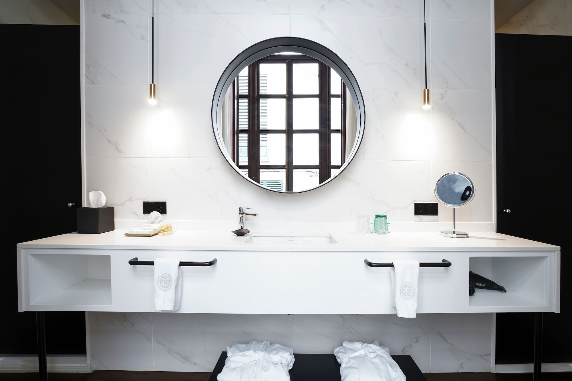 a bathroom with a round mirror