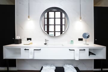 a bathroom with a round mirror