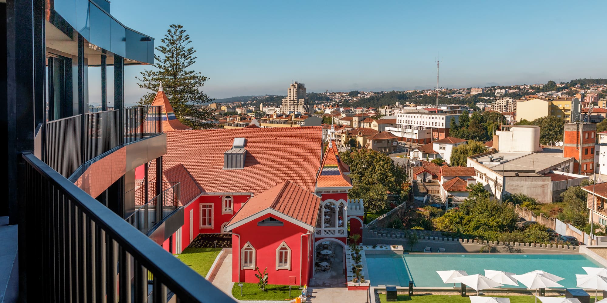 a building with a pool and lawn in a city