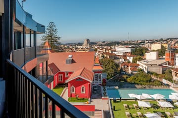a building with a pool and lawn in a city