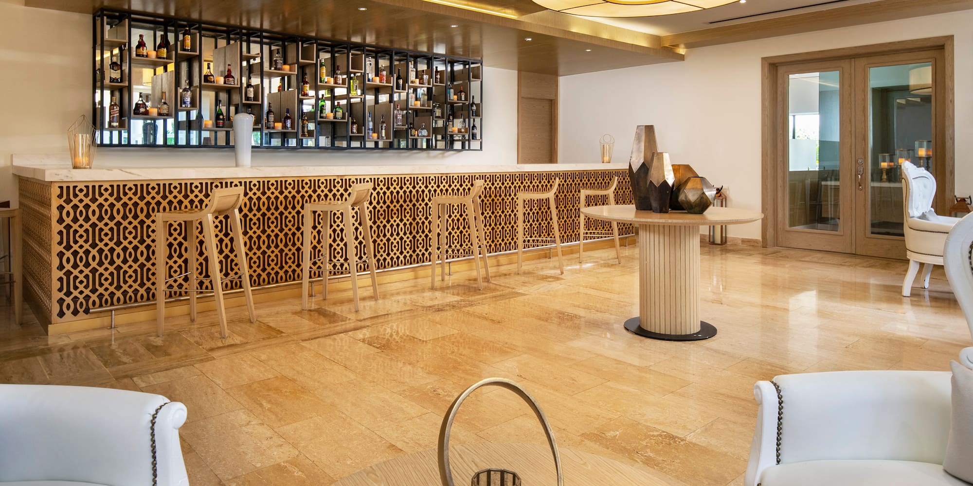 a room with a bar and a shelf with bottles