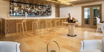 a room with a bar and a shelf with bottles