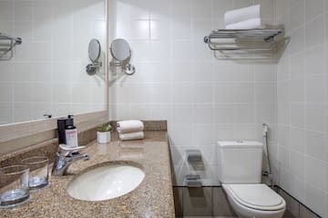 a bathroom with a marble countertop sink and toilet