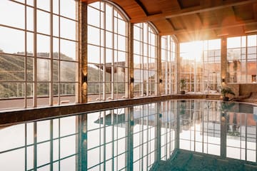 a large indoor pool with large windows