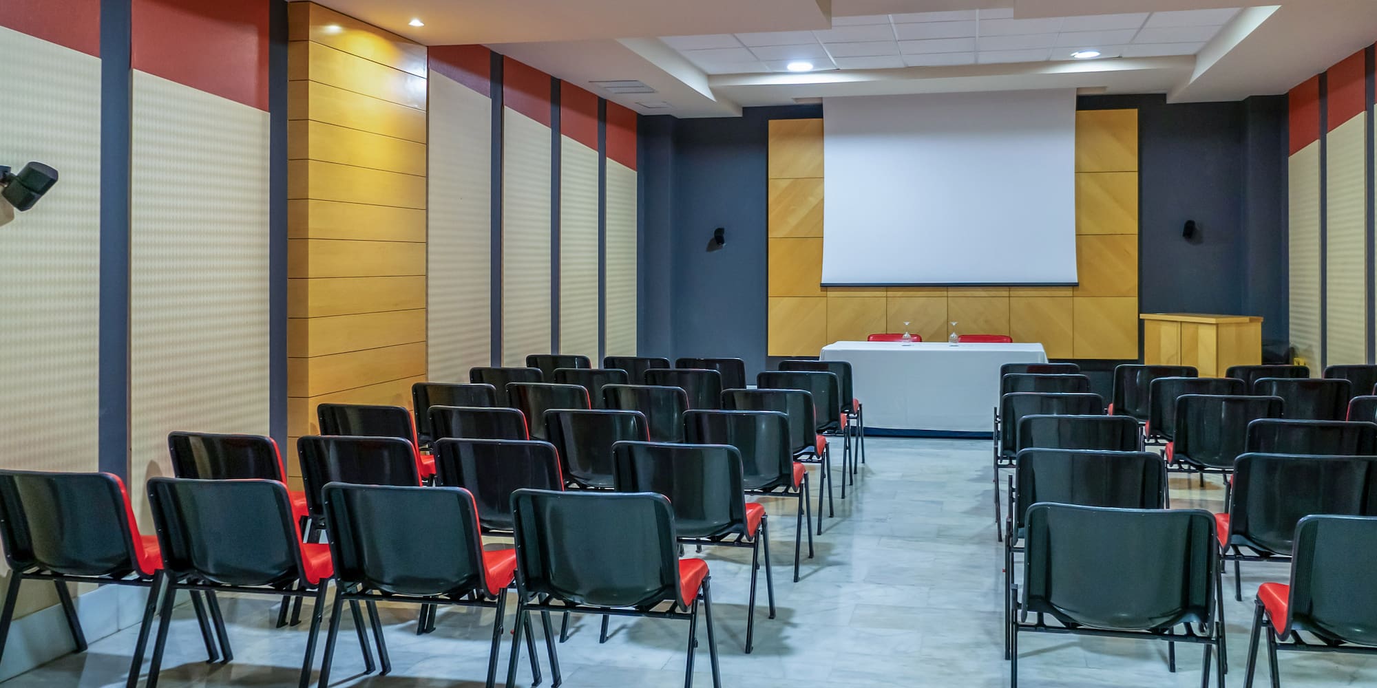 a room with chairs and a projector screen
