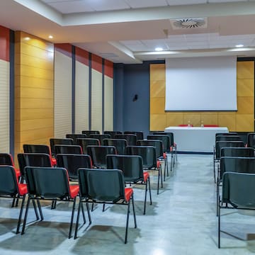 a room with chairs and a projector screen