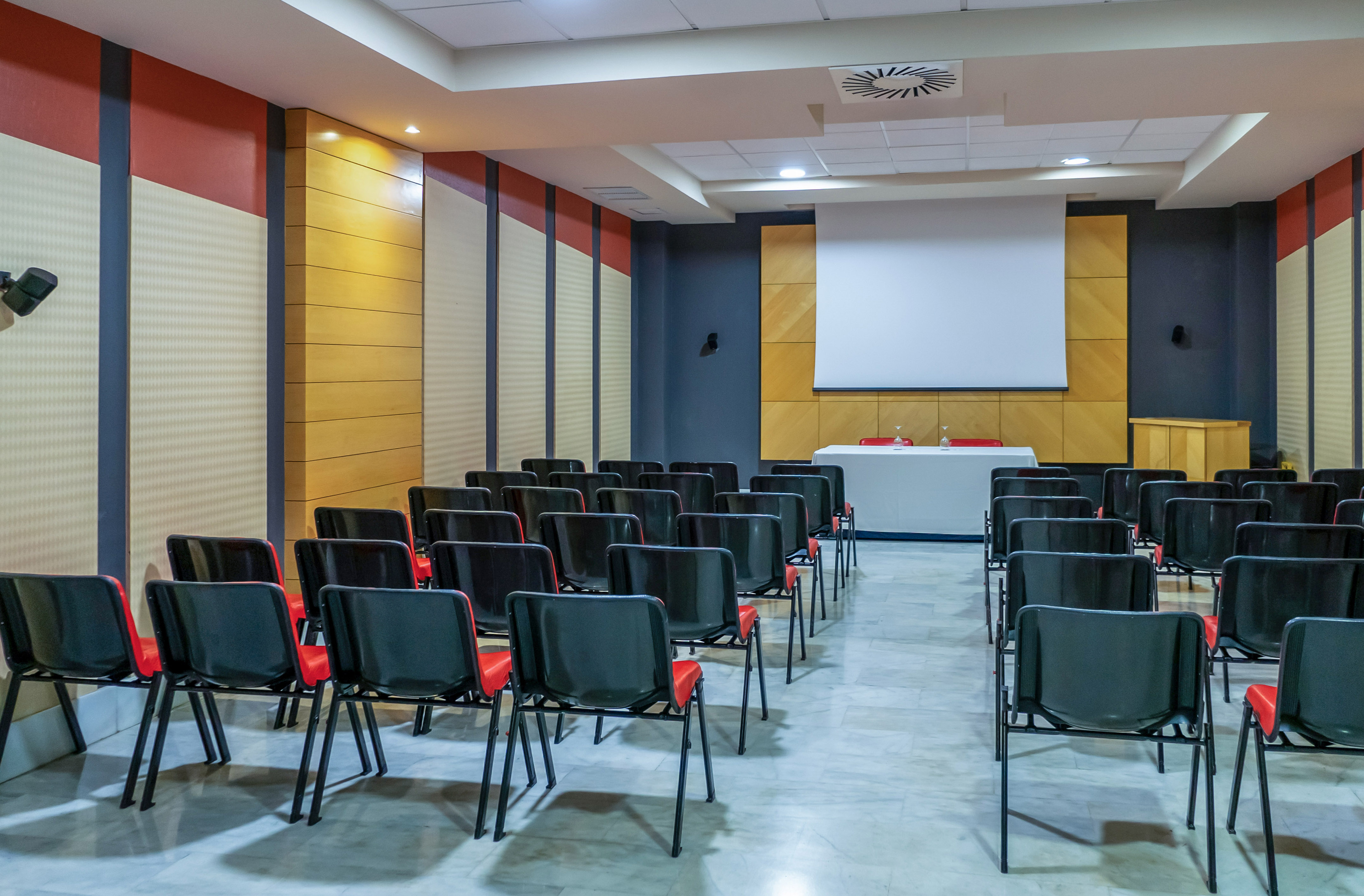 a room with chairs and a projector screen