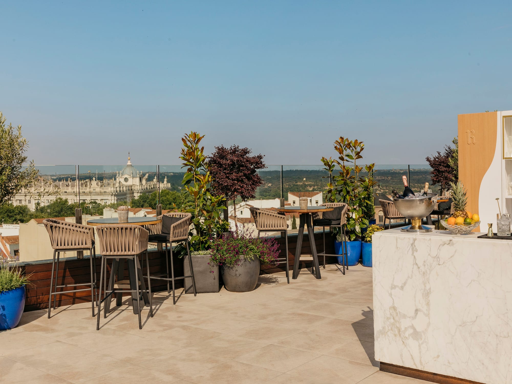 a patio with chairs and tables and trees