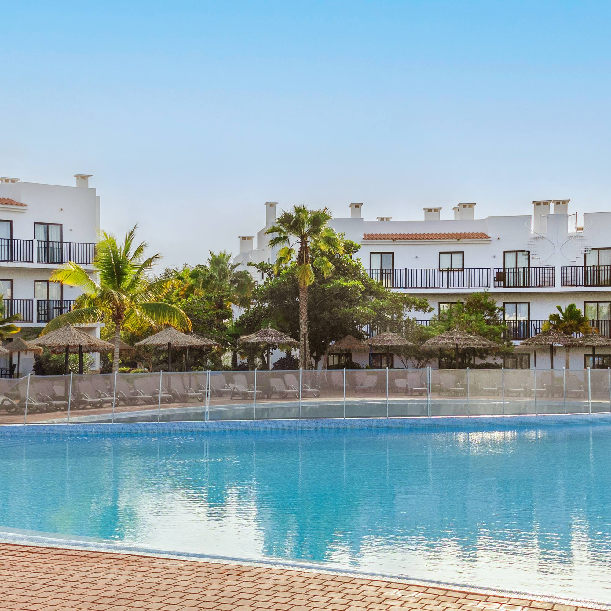 a pool with a building in the background