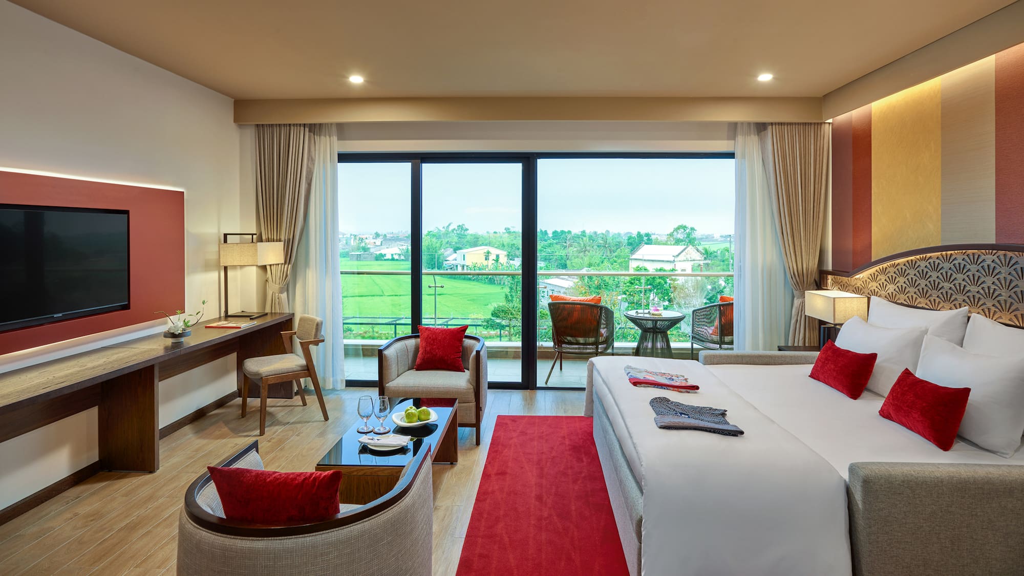 a room with a bed and chairs and a table