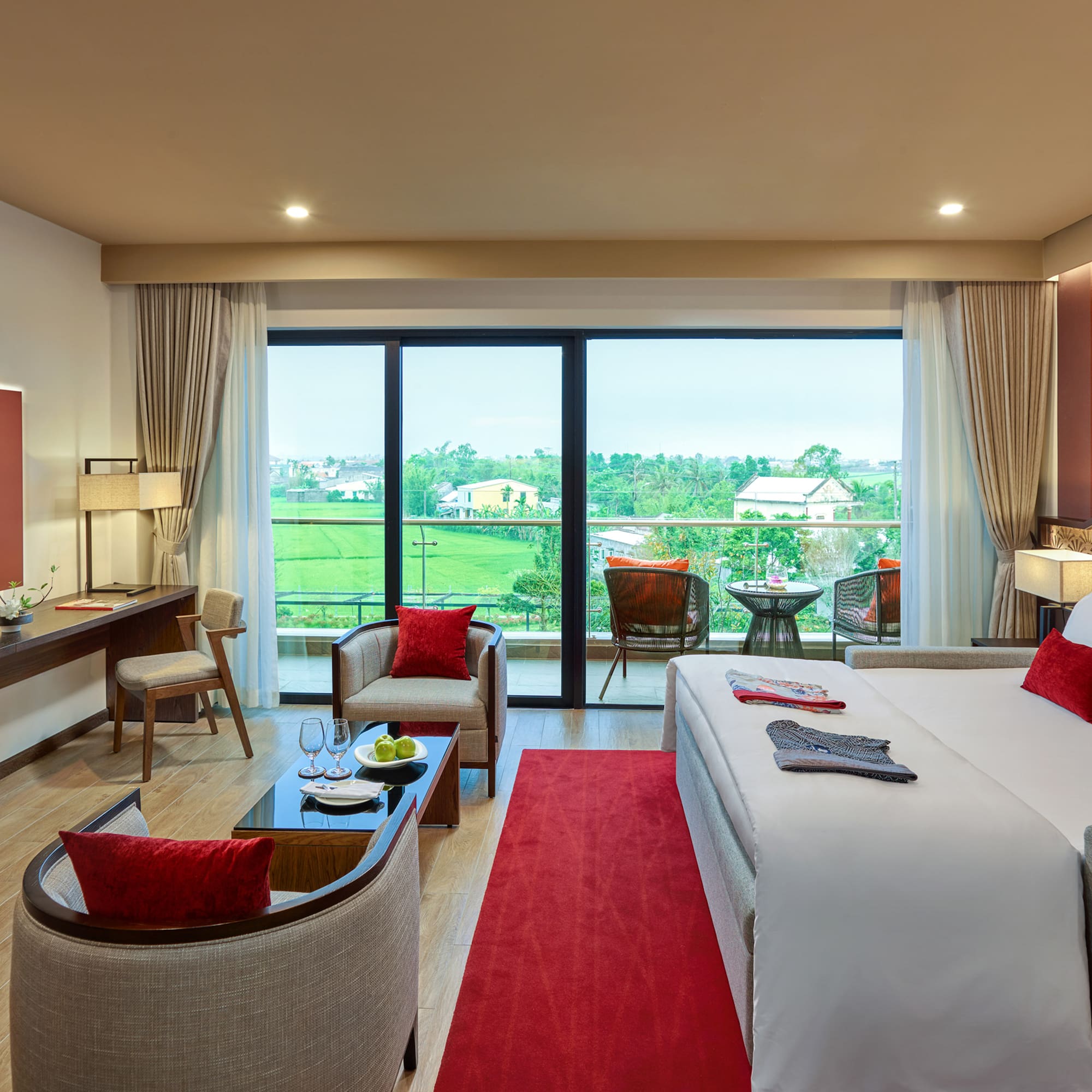 a room with a bed and chairs and a table