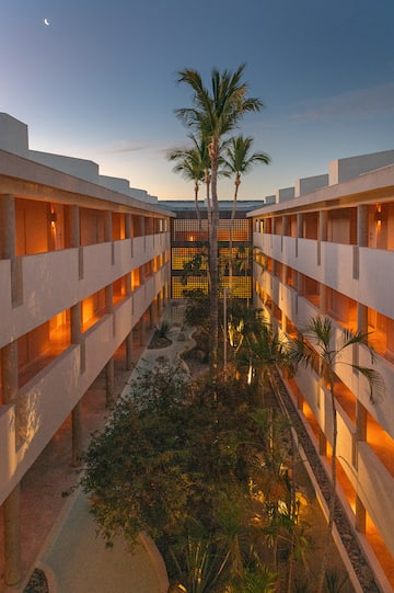 a building with many windows and trees